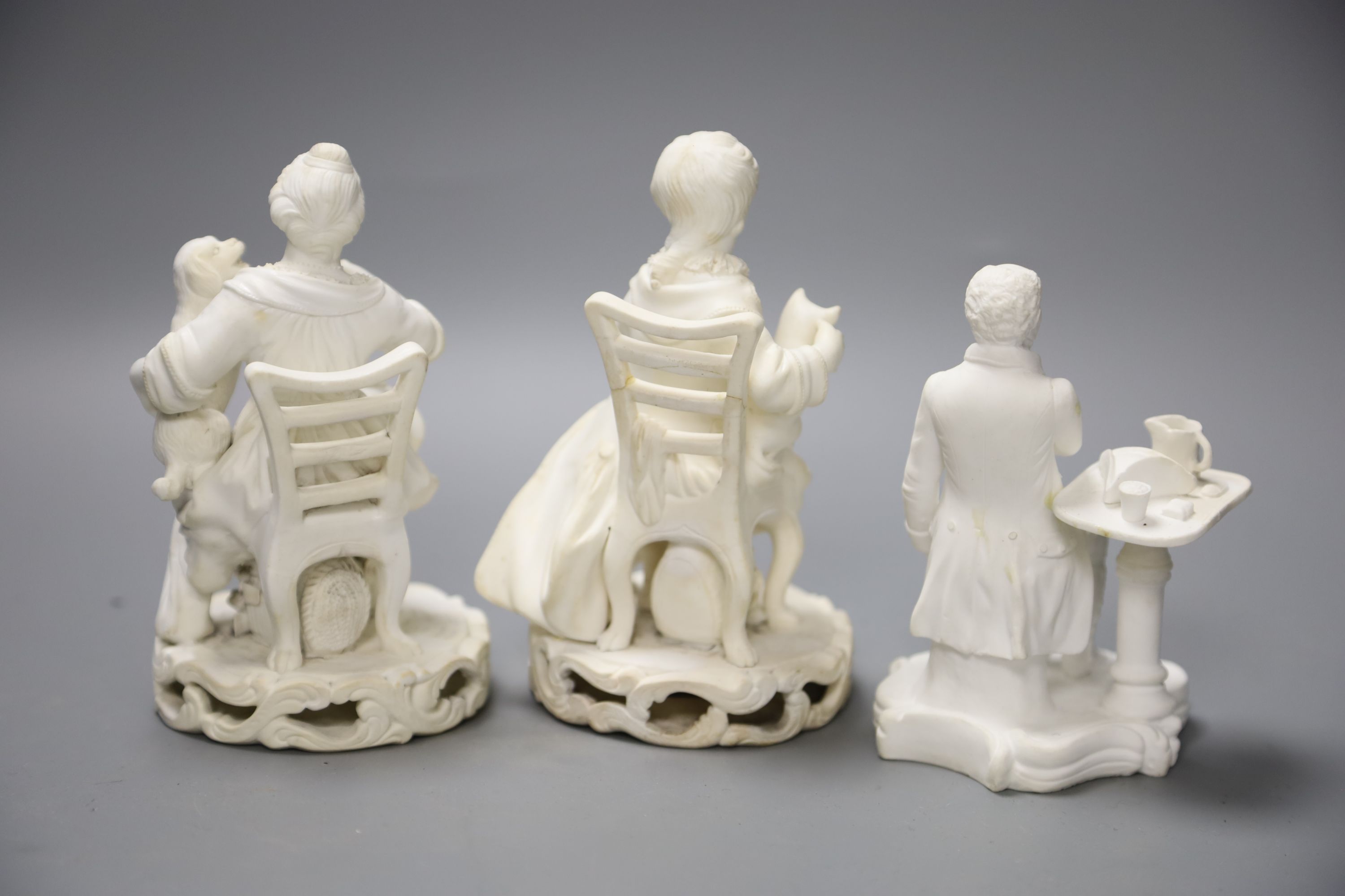 An early 19th century pair of Derby biscuit figures of a boy with a cat and a girl with a dog and a Minton figure of a Chelsea pensione